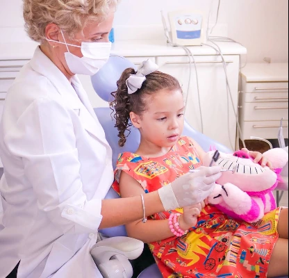 Dra. Elisa atendendo uma criança no consultório